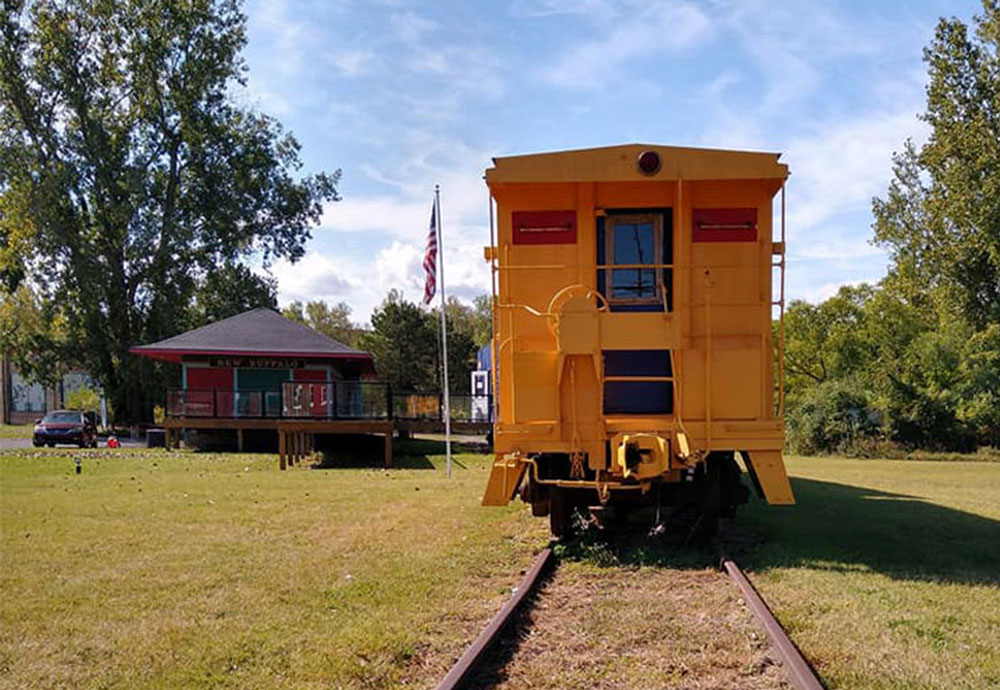 Summer day with a view of a yellow train car