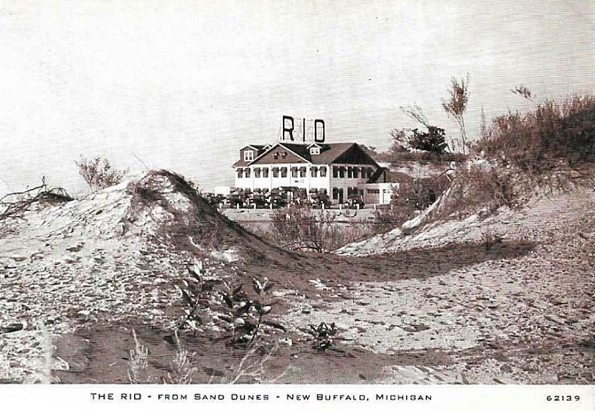 antique photo of a sandy beach area with a large white building called The Rio